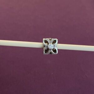 Pandora Retired Four Petal Flower Sterling silver and clear zirconia charm.